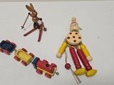 three wooden toys that are on a white surface