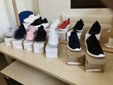 many pairs of shoes sitting on a table in a room