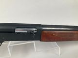 a shotgun that is sitting on top of a clear stand