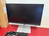 a computer monitor sitting on top of a red table