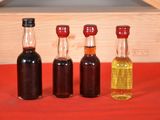 three bottles of syrup sit next to each other on a table