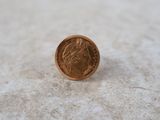 a close up of a coin on a table with a blurry background