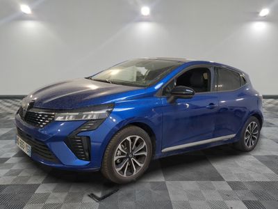 a blue car is parked on a checkered floor in a garage