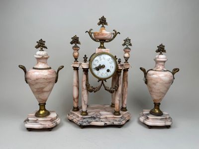 three vases and a clock sitting on top of a table