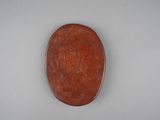 a picture of a brown oval shaped object on a white surface