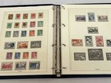 an open book with stamps on it sitting on a table