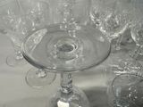 many wine glasses sitting on a table next to each other