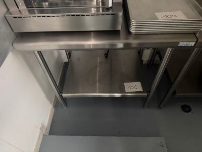 a stainless steel counter top with a bunch of trays on it