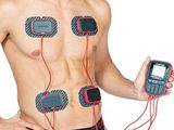 a man holding a cell phone with electrodes attached to it