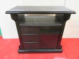 a black table with drawers and a shelf on top of it