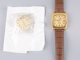 a watch that is sitting next to a piece of paper