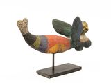 statue of a colorful bird on a wooden base
