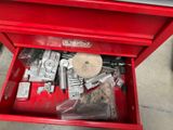 a red tool box with tools in it on the floor