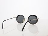 sunglasses on a white table with a white background
