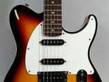 an electric guitar sitting on top of a white surface
