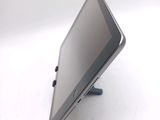 a tablet computer sitting on a stand on a white surface