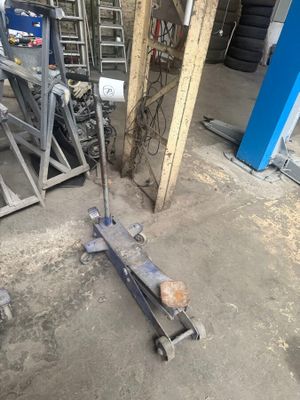 an image of a garage with tools on the floor