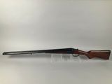a rifle with a wooden barrel on a white background