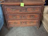 une commode dans une pièce où se trouve un canapé