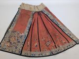 an orange skirt with black trim and a floral design on the bottom