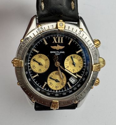 a close up of a wrist watch with a black dial