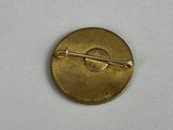 a close up of a gold pin with a pin on it