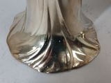 a silver statue of a woman on a white table
