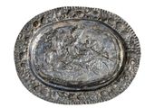 an image of a silver plate with a picture of a man on a horse