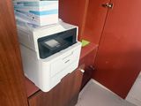 a printer sitting on top of a cabinet in a room
