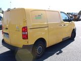 a yellow van that is parked in a parking lot