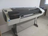a large printer sitting on a stand in a room