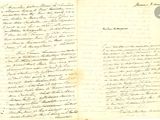an old handwritten letter is open on a piece of paper