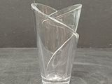 a glass vase with a wire wrapped around it on a table