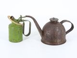 two old teapots sitting next to each other on a white surface