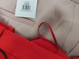 red pants with a price tag on a hanger in a store