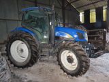a blue tractor that is parked inside of a building