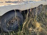 a truck that is sitting in the grass by itself