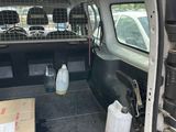 the back of a van with a caged in area and a box in the back of the van