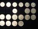 a lot of coins that are on a black surface