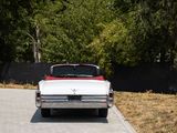 a red and white car parked on the side of the road