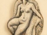 a stone sculpture of a woman sitting on a chair