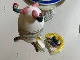 several figurines of people on top of a cake on a table