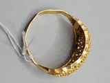 an image of a gold ring on a white surface with a string