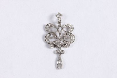 a close up of a diamond pendant on a white surface