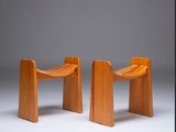 pair of wooden chairs with curved legs and a curved seat