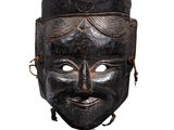 une image représentant un masque en bois au visage noir sur fond blanc