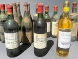 several bottles of wine are lined up in a row on a table