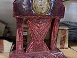 a clock that is sitting on a shelf in a room