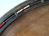 a close up of a drum with beads on it