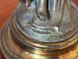 a bronze statue of a woman holding a dog